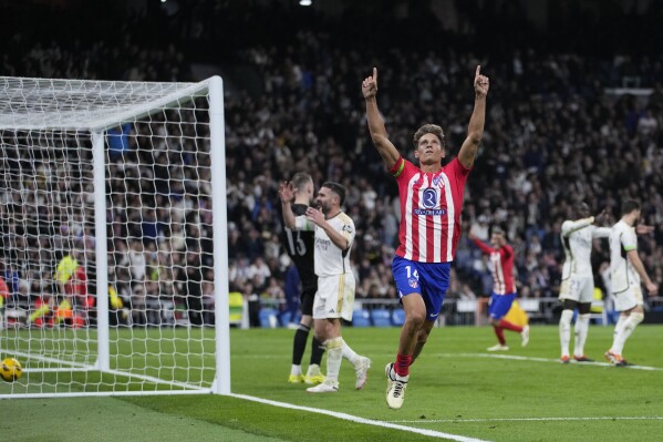 Atletico Madrid's Marcos Llorente celebrates after scoring his side's first goal during the Spanish La Liga soccer match between Real Madrid and Atletico Madrid at the Santiago Bernabeu stadium in Madrid, Spain, Sunday, Feb. 4, 2024. (AP Photo/Bernat Armangue)