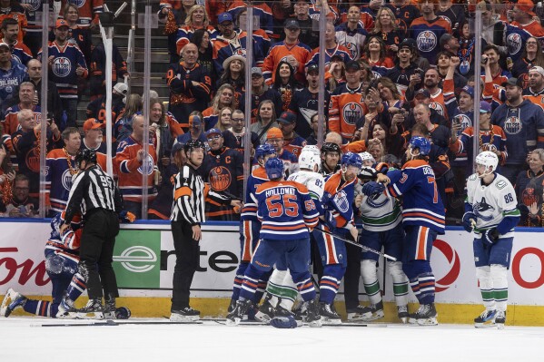 Vancouver Canucks and Edmonton Oilers rough it up during the third period of Game 6 of an NHL hockey Stanley Cup second-round playoff series, Saturday, May 18, 2024, in Edmonton, Alberta. (Jason Franson/The Canadian Press via AP)