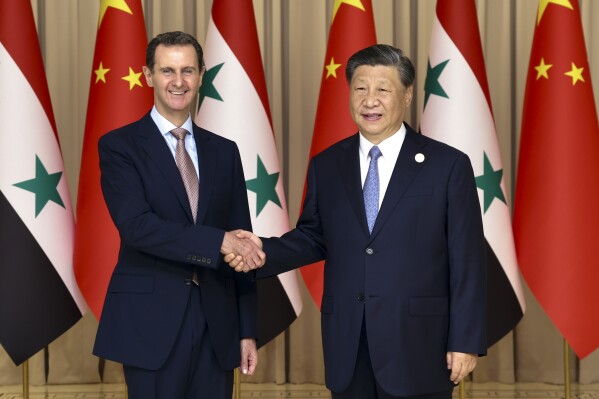 In this photo released by Xinhua News Agency, Chinese President Xi Jinping, right, shakes hands with Syrian President Bashar Assad before their bilateral meeting in Hangzhou, China, Friday, Sept. 22, 2023. China and Syria announced the formation of a strategic partnership on Friday as Chinese leader Xi Jinping kicked off a series of diplomatic meetings ahead of the upcoming Asian Games. (Yao Dawei/Xinhua via AP)