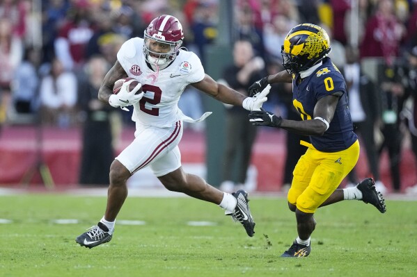 Alabama running back Jase McClellan (2) runs past Michigan defensive back Mike Sainristil (0) during the second half in the Rose Bowl CFP NCAA semifinal college football game Monday, Jan. 1, 2024, in Pasadena, Calif. (AP Photo/Mark J. Terrill)