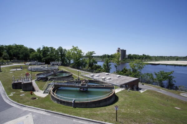 Tanks hold water at the Sweeney Water Treatment Plant as the Northeast Cape Fear River flows past in Wilmington, N.C., Monday, April 28, 2025. (AP Photo/Ben McKeown)