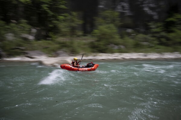 A tourist practices packrafting along the Verdon Gorge in southern France, Monday, June 19, 2023. (AP Photo/Daniel Cole)