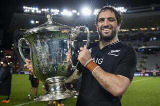 FILE - New Zealand All Blacks captain Sam Whitelock holds the Bledisloe Cup after they defeated Australia 57-22 in the second rugby test at Eden Park in Auckland, New Zealand, on Aug. 14, 2021. (Brett Phibbs/Photosport via AP, File)