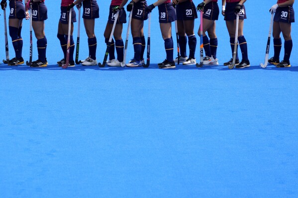 Spanish players line up to greet their opponents before the start of the women's Group B field hockey match between Australia and Spain at the Yves-du-Manoir Stadium during the 2024 Summer Olympics, Saturday, Aug. 3, 2024, in Colombes, France. (AP Photo/Aijaz Rahi)