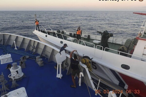 In this handout photo provided by the Philippine Coast Guard, a Chinese coast guard ship approaches a Philippine coast guard ship, foreground, causing a minor collision, in the vicinity of Second Thomas Shoal on Tuesday, March 5, 2024. The vessels collided in the disputed South China Sea, slightly injuring four Filipino crewmen in a new confrontation that unfolded as Southeast Asian leaders gathered for an Asian summit where alarm over Beijing’s aggression at sea was expected to be raised. (Philippine Coast Guard via AP)