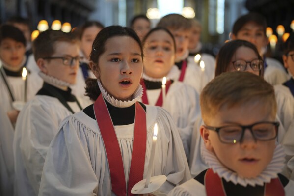 The Choristers of St Paul's choir, including girls for first time in 900-year history, rehearse for the Christmas services in St Paul's Cathedral, in London, Monday, Dec. 23 2024. (AP Photo/Kin Cheung)