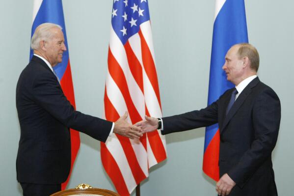 FILE - In this March 10, 2011, file photo, then Vice President Joe Biden, left, shakes hands with Russian Prime Minister Vladimir Putin in Moscow, Russia.   (AP Photo/Alexander Zemlianichenko, File)