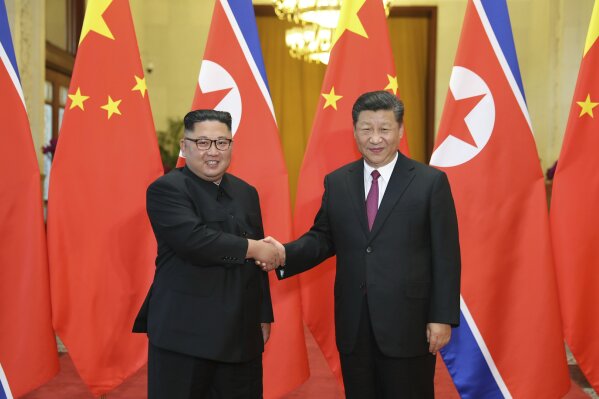 FILE - In this June 19, 2018, file photo released by China's Xinhua News Agency, Chinese President Xi Jinping, right, poses with North Korean leader Kim Jong Un for a photo during a welcome ceremony at the Great Hall of the People in Beijing. Chinese state media say President Xi Jinping will make a state visit to North Korea this week. State broadcaster CCTV said in its evening news program on Monday that Xi will meet with North Korean leader Kim Jong Un during a visit Thursday and Friday. (Ju Peng/Xinhua via AP, File)