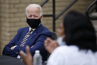 Democratic presidential candidate, former Vice President Joe Biden, left, listens as Carlette Brooks, owner of Carlette's Hideaway, a soul food restaurant, talks during a meeting with small business owners, Wednesday, June 17, 2020, in Yeadon, Pa. (AP Photo/Matt Slocum)
