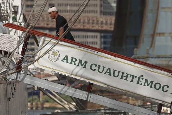 A sailor on Sunday, May 18, 2025, in New York, a Mexican training ship that collided with the Brooklyn Bridge the evening before. (AP Photo/Yuki Iwamura)