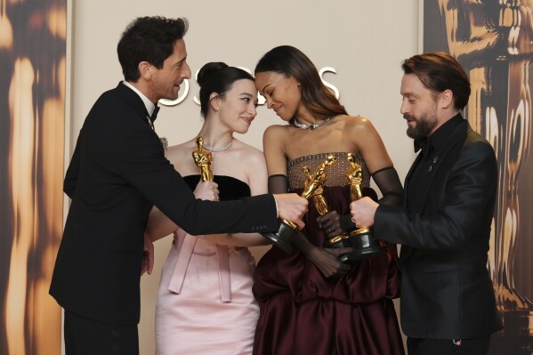 Adrien Brody, from left, winner of the award for best performance by an actor in a leading role for "The Brutalist," Mikey Madison, winner of the award for best performance by an actress in a leading role for "Anora," Zoe Saldana, winner of the award for best performance by an actress in a supporting role for "Emilia Perez," and Kieran Culkin, winner of the award for best performance by an actor in a supporting role for "A Real Pain," pose in the press room at the Oscars on Sunday, March 2, 2025, at the Dolby Theatre in Los Angeles. (Photo by Jordan Strauss/Invision/AP)