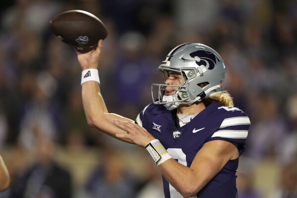 Kansas State quarterback Avery Johnson passes during the first half of an NCAA college football game against Arizona State Saturday, Nov. 16, 2024, in Manhattan, Kan. (AP Photo/Charlie Riedel)