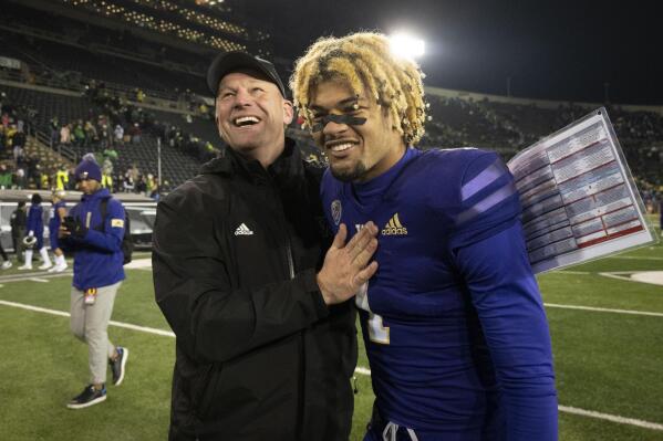 Washington head coach Kalen DeBoer, front left, celebrates with Washington wide receiver Rome Odunze (1) after they defeated Oregon in an NCAA college football game Saturday, Nov. 12, 2022, in Eugene, Ore. (AP Photo/Andy Nelson)