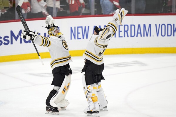 Boston Bruins goaltenders Jeremy Swayman, left, and Linus Ullmark celebrate after the Bruins beat the Florida Panthers 2-1 during Game 5 of the second-round series of the Stanley Cup Playoffs, Tuesday, May 14, 2024, in Sunrise, Fla. (AP Photo/Wilfredo Lee)