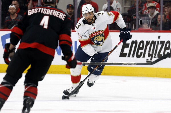 Florida Panthers' Seth Jones (3) states with the puck against the Carolina Hurricanes during the first period of Game 1 of the NHL hockey Stanley Cup Eastern Conference finals in Raleigh, N.C., Tuesday, May 20, 2025. (AP Photo/Karl DeBlaker)