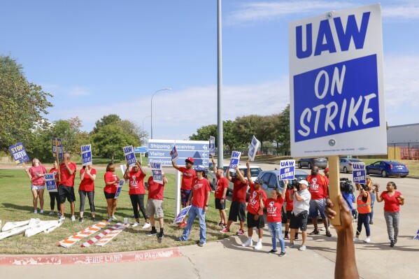 UAW members cheer as employees walkout from the General Motors' Fort Worth Parts Distribution Center, on Friday, Sept. 22, 2023, in Roanoke, Texas. (Shafkat Anowar/The Dallas Morning News via AP)