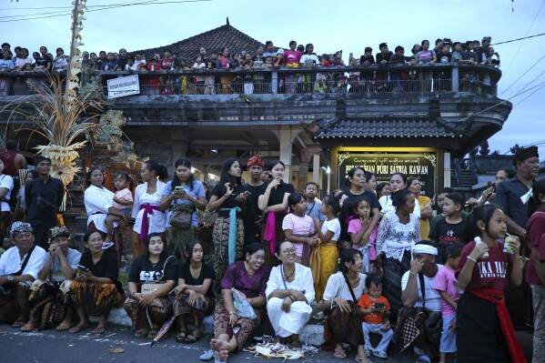 Residents watch an Ogoh-ogoh parade in Klungkung village, Bali, Indonesia on Sunday, March 10, 2024. The noisy "ogoh-ogoh" processions feature giant scary figures that symbolize evil spirits and are burned in a ritualistic purification, signifying the victory of good over evil.(AP Photo/Firdia Lisnawati)