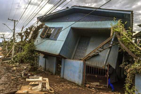 A home leans in on itself, destroyed by a deadly cyclone in Roca Sales, Rio Grande do Sul state, Brazil, Thursday, Sept. 7, 2023. Flooding from a cyclone in southern Brazil has washed away houses, trapped motorists in vehicles and swamped streets in several cities. (AP Photo/Wesley Santos)