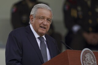 FILE - Mexican President Andres Manuel Lopez Obrador speaks during a military parade in Mexico City, Aug. 13, 2021. Mexico’s president acknowledged Tuesday, Feb. 20, 2024 that the armed forces will take over fixing the nation’s highways. (AP Photo/Fernando Llano, File)