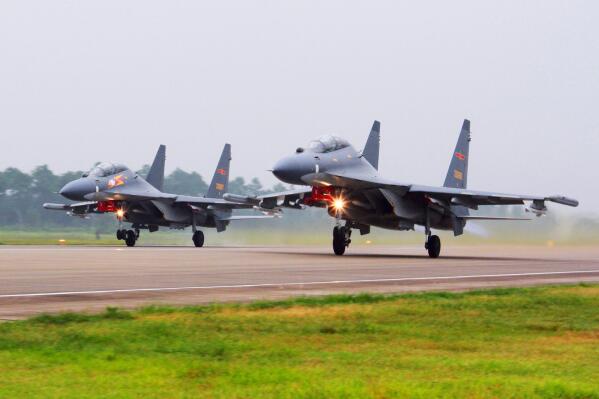 FILE - In this undated file photo released by China's Xinhua News Agency, two Chinese SU-30 fighter jets take off from an unspecified location to fly a patrol over the South China Sea. With record numbers of military flights near Taiwan over the last week, China has been showing a new intensity and sophistication as steps up its harassment of the island it claims as its own and asserts its territorial claims in the region. (Jin Danhua/Xinhua via AP, File)