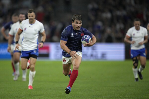 France's Antoine Dupont runs in to score his side's seventh try during the Rugby World Cup Pool A match between France and Namibia at the Stade de Marseille in Marseille, France, Thursday, Sept. 21, 2023. (AP Photo/Daniel Cole)