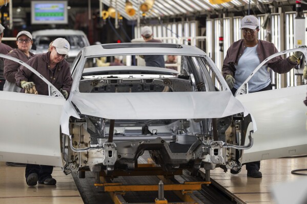 FILE - In this Aug. 31, 2017, file photo, workers produce vehicles at Volkswagen's U.S. plant in Chattanooga, Tenn. More than 1,000 workers at the Tennessee factory have signed cards authorizing a vote to be represented by the United Auto Workers union. It's the first plant in the nation to reach that milestone in the UAW’s quest to organize more than a dozen nonunion factories. The union says in a statement Thursday, Dec. 7, 2023 that the workers signed on in less than a week. (AP Photo/Erik Schelzig, File)