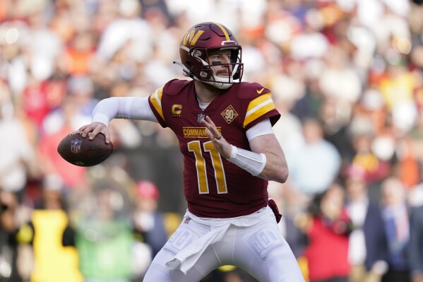 FILE - Washington Commanders quarterback Carson Wentz throws to a receiver in the first half of an NFL football game against the Cleveland Browns, Sunday, Jan. 1, 2023, in Landover, Md. The Los Angeles Rams are signing quarterback Carson Wentz, a person with knowledge of the deal tells The Associated Press. The source spoke on condition of anonymity Tuesday, Nov. 7, because Wentz needed to pass a physical before the deal could be announced. (AP Photo/Patrick Semansky, File)