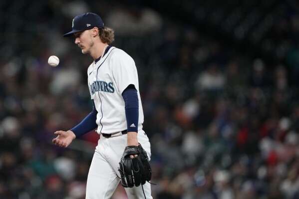 Seattle Mariners starting pitcher Bryce Miller reacts after giving up a single to Atlanta Braves' Ronald Acuña Jr. during the seventh inning of a baseball game Monday, April 29, 2024, in Seattle. (AP Photo/Lindsey Wasson)