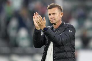 FILE - Leipzig's head coach Jesse Marsch applauds after their German Bundesliga soccer match against VfL Wolfsburg in Wolfsburg, Germany, Aug. 29, 2021. American coach Jesse Marsch has been hired by Leeds it was announced Monday, Feb. 28, 2022 and the club is hoping a late-season change in manager can help to preserve its English Premier League status. Marsch replaces Marcelo Bielsa and is back in work nearly three months after leaving German team Leipzig. (AP Photo/Michael Sohn, file)