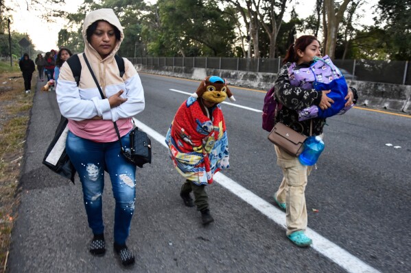 Women and children migrants walk with a larger group of migrants through Tapachula, Chiapas state, Mexico, in an attempt to reach the U.S. border, Jan. 20, 2025, the inauguration day of U.S. President Donald Trump. (AP Photo/Edgar H. Clemente, FIle)