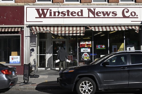 FILE - Andy Thibault, Editor and Publisher of The Winsted Citizen, carries bundles of the paper into the Winsted News Co., Friday, Feb. 3, 2023, in Winsted, Conn. American Business Media said Wednesday, Nov. 22 that it has acquired the Winsted Citizen, whose oversight board had decided only two days earlier that it could no longer operate because of financial woes. Terms were not disclosed. (AP Photo/Jessica Hill, File)