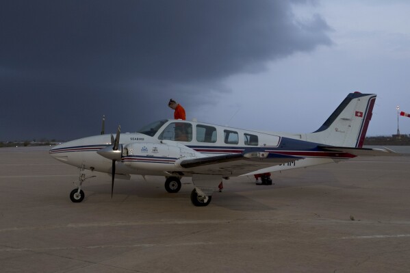 FILE - Eike Bretschneider exits the Seabird aircraft after flying for nearly six hours before running low on fuel over the Mediterranean Sea north of Libya, as a storm approaches the island of Lampedusa, Italy, Tuesday, Oct. 5, 2021. Italy’s aviation authority has barred humanitarian migrant rescue groups from using a Sicilian airport to launch search and rescue flights over the Mediterranean, in the government’s latest crackdown on their activities. (AP Photo/Renata Brito, File)