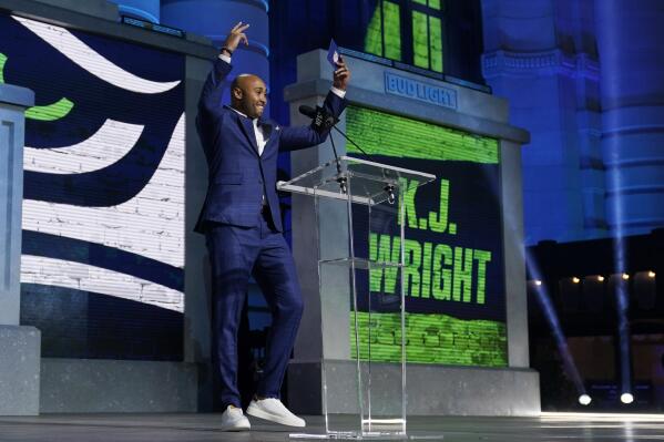 Former football player K. J. Wright reacts before announcing UCLA running back Zach Charbonnet as the selection by the Seattle Seahawks during the second round of the NFL football draft, Friday, April 28, 2023, in Kansas City, Mo. (AP Photo/Jeff Roberson)