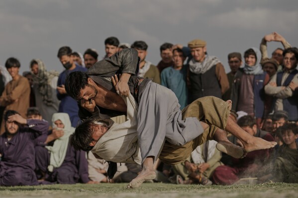 Afghan wrestlers fight during a match at the Chaman-e-Hozari Park in Kabul, Afghanistan, May 30, 2025. (AP Photo/Ebrahim Noroozi)