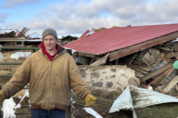 Matt Artis, 34, surveys the wreckage Friday morning, Feb. 9, 2024, after a tornado struck his farm in the Town of Porter, Wis., on Thursday evening. A line of storms and tornadoes fueld by unusually warm February weather tore across southeastern Wisconsin on Thursday. (APPhoto/Todd Richmond)