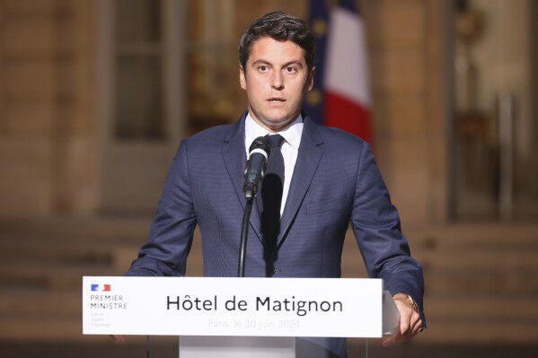 French Prime Minister Gabriel Attal delivers a speech in the courtyard of the Prime Minister's residence, Sunday, June 30, 2024 in Paris. (AP Photo/Thomas Padilla)