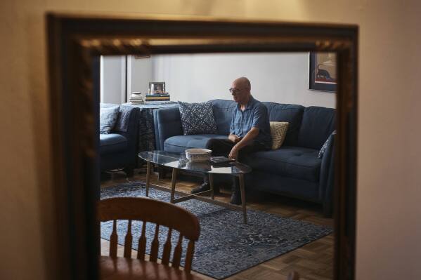 Ron Spitzer, stroke survivor, rests at home on Monday, July 15, 2024, in New York. In the 1980s and ’90s, h played bass and drums in rock bands, but a stroke in 2009 put Spitzer in a wheelchair, his voice a whisper. (AP Photo/Andres Kudacki)