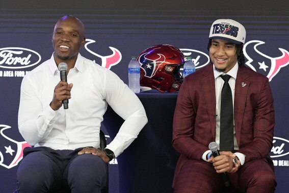 FILE - Houston Texans head coach DeMeco Ryans, left, talks about NFL football first-round draft pick quarterback C.J. Stroud, right, during an introductory news conference Friday, April 28, 2023, in Houston. After three seasons as one of the league’s worst teams, the Texans have tasked Ryans with turning around the franchise in his first head coaching job. (AP Photo/Kevin M. Cox)