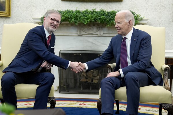 President Joe Biden, right, and Prime Minister Petr Fiala of the Czech Republic shake hands during a meeting in the Oval Office at the White House, Monday, April 15, 2024. (AP Photo/Manuel Balce Ceneta)