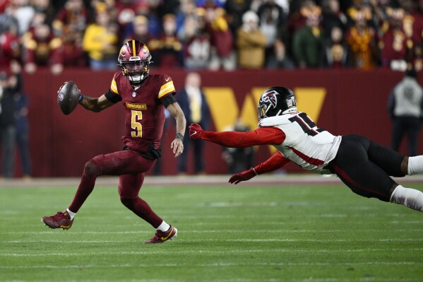 Jayden Daniels carries the Commanders into the playoffs by running as much  as throwing | AP News
