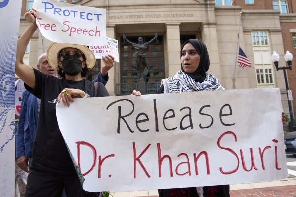Mapheze Saleh, right, wife of arrested and detained Georgetown University scholar Badar Khan Suri, holds a sign calling for her husband's release after speaking at a news conference following his hearing at Federal District Court for the Eastern District of Virginia, in Alexandria, Va., Thursday, May 1, 2025. (AP Photo/Jacquelyn Martin, File)
