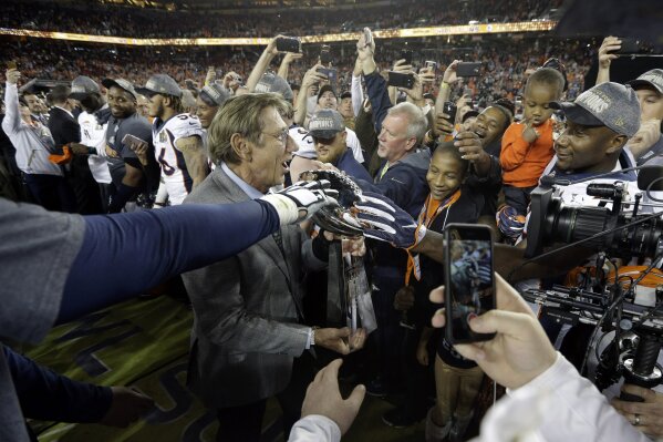 FILE - In this Feb. 7, 2016, file photo, Joe Namath, MVP of Super Bowl III, carries the Lombardi Trophy onto the field for the postgame ceremony after the NFL Super Bowl 50 football game between the Denver Broncos and the Carolina Panthers, in Santa Clara, Calif.  Just over 50 years ago, halfway through the history of the NFL, the New York Jets completed one of the most unexpected championship seasons in the history of the sport when a brash quarterback named Joe Namath helped engineer a Super Bowl victory over the heavily favored Baltimore Colts. That now-famous journey by Broadway Joe and the boys through the AFL that ended in triumph in Miami took a lesser-known detour for the second week of the schedule. Yes, for one weekend, the Jets actually landed in Birmingham, Alabama, at Legion Field. (AP Photo/Julie Jacobson, File)