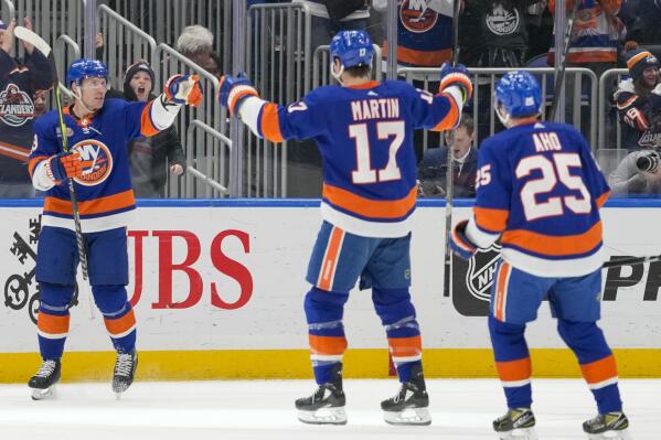 New York Islanders center Casey Cizikas, left, celebrates after scoring against the Montreal Canadiens during the first period of an NHL hockey game, Saturday, Jan. 14, 2023, in Elmont, N.Y. (AP Photo/Mary Altaffer)