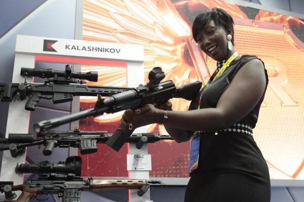 FILE - A visitor handles a gun at an exhibition by the Kalashnikov company on the sidelines of the Russia-Africa summit in the Black Sea resort of Sochi, Russia on Oct. 24, 2019. Amid a worldwide chorus of condemnation against Russia's war on Ukraine, Africa has remained mostly quiet — a reminder of the Kremlin's considerable influence over the continent. (Sergei Chirikov, Pool Photo via AP, File)
