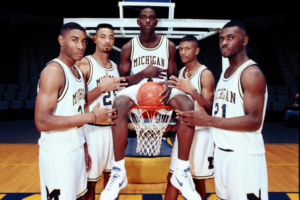 FILE - Michigan's Fab Five from left, Jimmy King, Juwan Howard, Chris Webber, Jalen Rose and Ray Jackson pose in November 1991, in Ann Arbor, Mich. Thirty years ago, a group of disrupters with baggy shorts and black socks changed college basketball as we know it, and took a good slice of American culture along for the ride. Those Michigan freshmen known as the Fab Five ended up one win short of the title, which is exactly where San Diego State — a team coached by a former Fab Five assistant, Brian Dutcher — finds itself in 2023 during another transformative period in college hoops. (AP Photo/File)