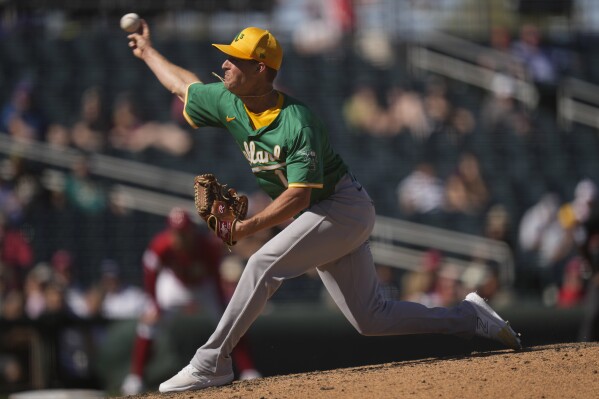 Oakland Athletics relief pitcher Trevor Gott throws during the fourth inning of a spring training baseball game against the Cincinnati Reds, Monday, March 4, 2024, in Goodyear, Ariz. (AP Photo/Carolyn Kaster)