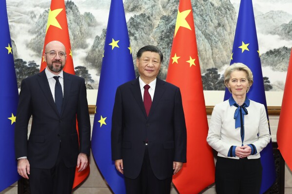 In this photo released by Xinhua News, Agency, Chinese President Xi Jinping, center, stands for a group photograph with European Commission President Ursula von der Leyen, right, and European Council President Charles Michel prior to their meeting at the Diaoyutai State Guesthouse in Beijing, Thursday, Dec. 7, 2023. The leaders of China and the European Union were holding wide-ranging talks Thursday that included their disputes over trade and a deep divide on the war in Ukraine. (Huang Jingwen/Xinhua via AP)