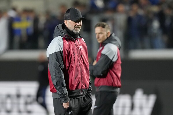 Liverpool's manager Jurgen Klopp walks on the pitch during warmup before the Europa League quarterfinal, second leg, soccer match between Atalanta and Liverpool at the Stadio di Bergamo, in Bergamo, Italy, Thursday, April 18, 2024. (Ǻ Photo/Antonio Calanni)