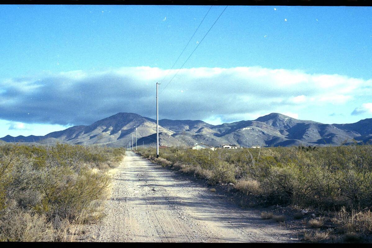 A dirt road leads to what was once the home of Paul Adams and his family on the outskirts of Bisbee, Ariz., Oct. 26, 2021. Adams, a Mormon and U.S. Border Patrol agent living with his wife and six children, admitted he had posted videos on the dark web of him molesting two of his children, a 9-year-old girl and a younger daughter he began raping when she was only 6 months old. Adams killed himself after his arrest. The revelation that Mormon officials directed an effort to conceal years of abuse in the Adams household sparked a criminal investigation of the church by Cochise County attorney and a civil lawsuit by three of the Adams' children. (AP Photo/Dario Lopez-Mills)