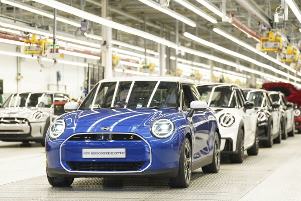 MINI cars stand in a row at the MINI plant at Cowley in Oxford, England, Monday, Sept. 11, 2023. German automaker BMW is set to announce plans to build the next generation electric Mini in Britain after securing U.K. government support for a multimillion-pound investment in the company’s Oxford factory. The government on Monday confirmed its backing for the project, which will protect 4,000 jobs. (Joe Giddens/PA via AP)